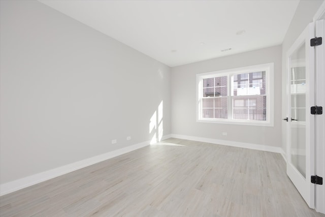 unfurnished room with light hardwood / wood-style flooring