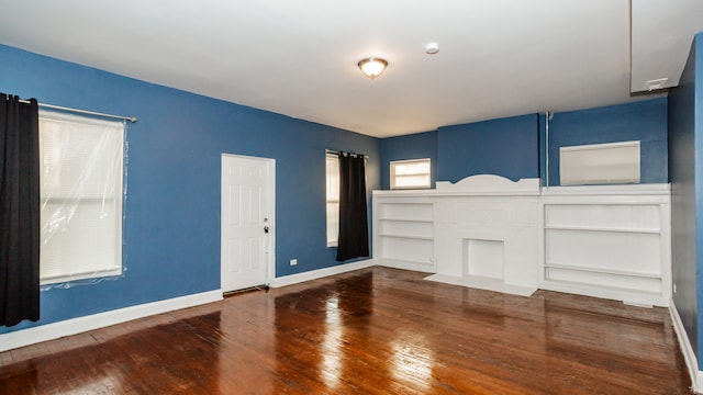 unfurnished living room with dark wood-type flooring