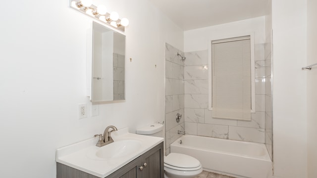 full bathroom with tiled shower / bath, vanity, and toilet