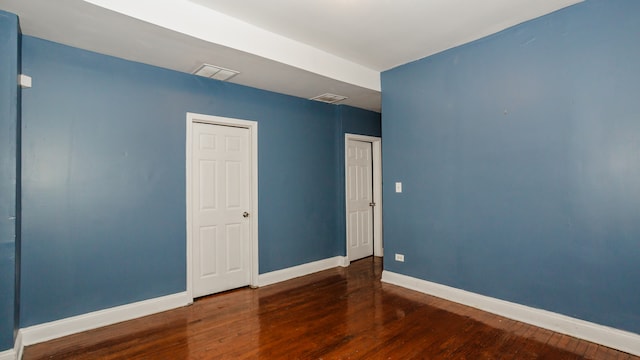 spare room with dark hardwood / wood-style flooring