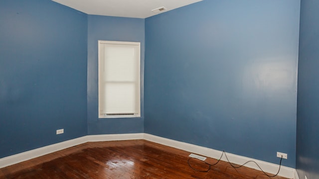 spare room featuring hardwood / wood-style flooring