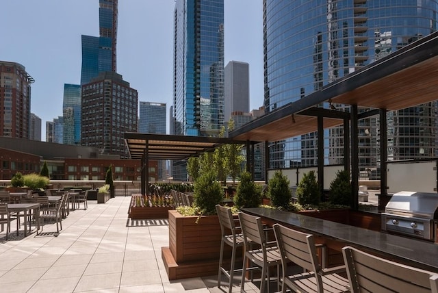 view of patio featuring a pergola, grilling area, and exterior bar