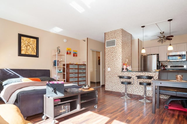 living room with ceiling fan and hardwood / wood-style floors