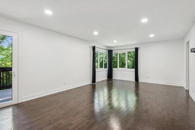 unfurnished room with dark wood-type flooring