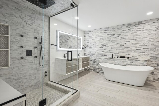 bathroom featuring sink, shower with separate bathtub, tile patterned flooring, and tile walls