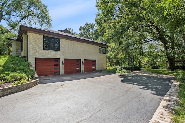 view of side of property with a garage