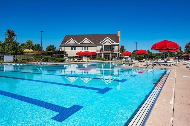 view of pool featuring fence