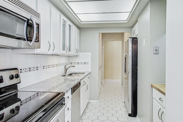 155 N Harbor Dr Unit 1003, Chicago, IL 60601 - kitchen featuring a sink, white cabinetry, appliances with stainless steel finishes, and light countertops