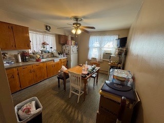 kitchen with white refrigerator, ceiling fan, and a healthy amount of sunlight