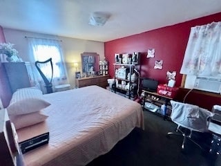 bedroom with cooling unit and dark colored carpet