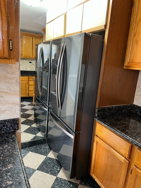 kitchen featuring tile patterned floors and stainless steel fridge with ice dispenser