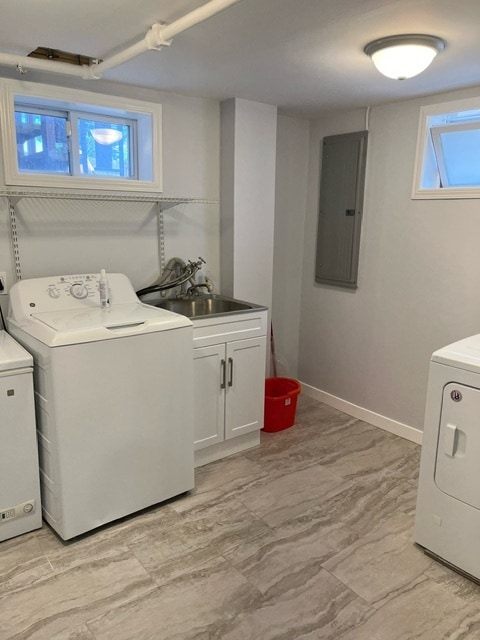 laundry area featuring sink, separate washer and dryer, cabinets, electric panel, and light tile patterned floors