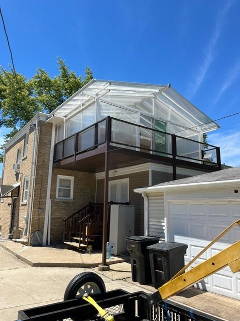 view of front of home featuring a balcony and a garage