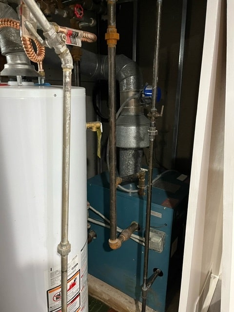 utility room with gas water heater