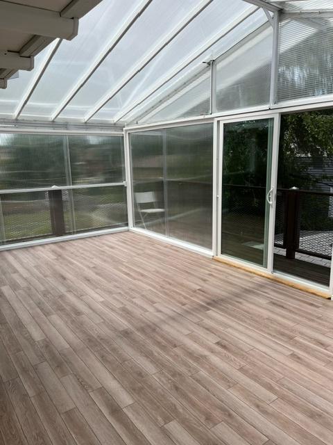 unfurnished sunroom featuring vaulted ceiling