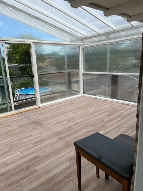 unfurnished sunroom with lofted ceiling