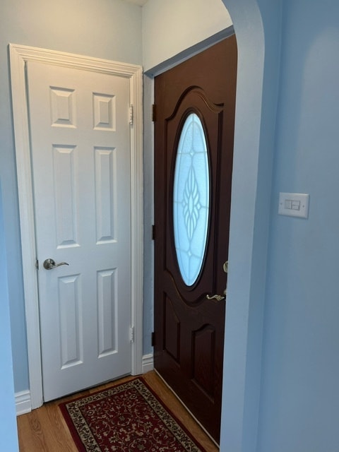 entryway with dark hardwood / wood-style flooring