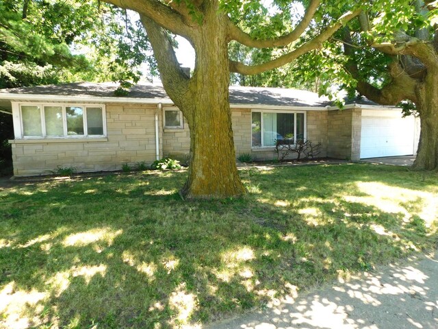 view of front of property with a garage and a front lawn