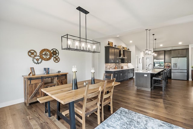 dining room with lofted ceiling, dark wood-style flooring, baseboards, and recessed lighting