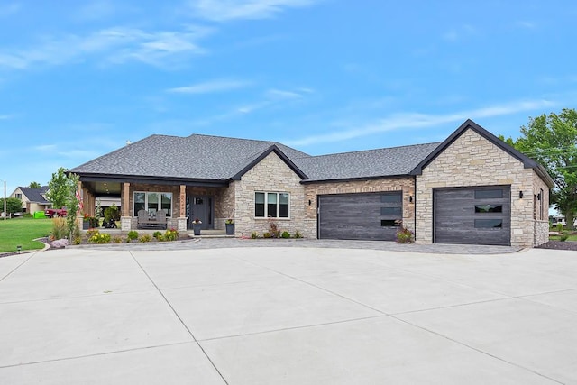 view of front of home featuring driveway, a porch, roof with shingles, and an attached garage