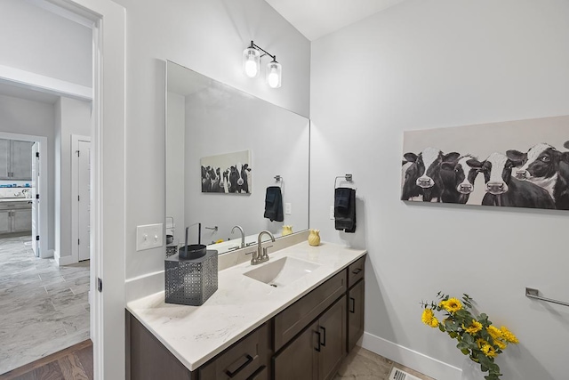 bathroom featuring vanity and baseboards