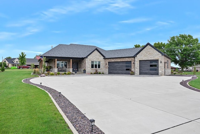 view of front of home with a shingled roof, covered porch, an attached garage, driveway, and a front lawn