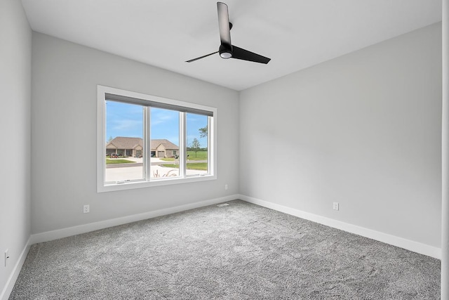 spare room featuring ceiling fan, carpet flooring, and baseboards