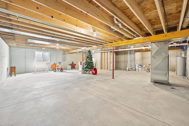 basement with heating unit, brick wall, electric panel, and gas water heater