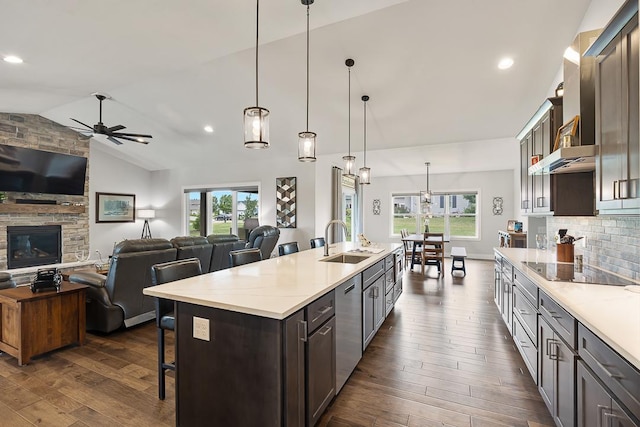 kitchen featuring open floor plan, a sink, stainless steel dishwasher, and black electric cooktop