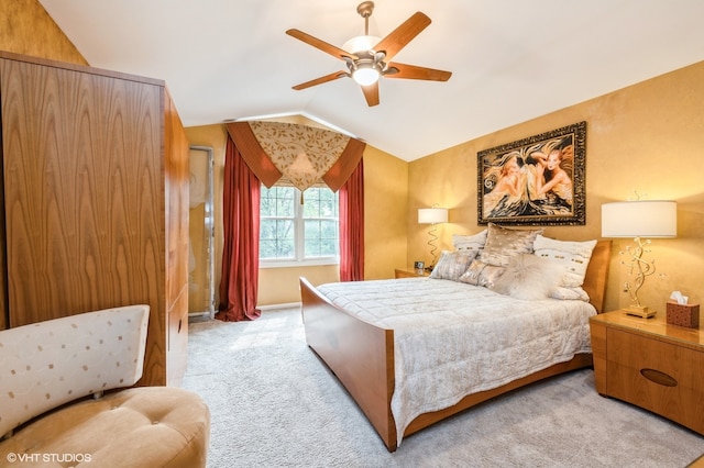 carpeted bedroom with lofted ceiling and ceiling fan