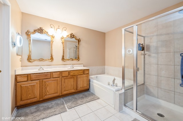 bathroom with tile patterned floors, dual vanity, and separate shower and tub