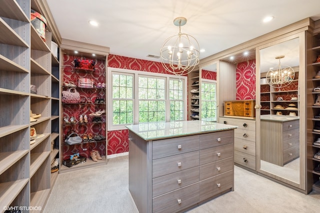 spacious closet with light carpet and a chandelier