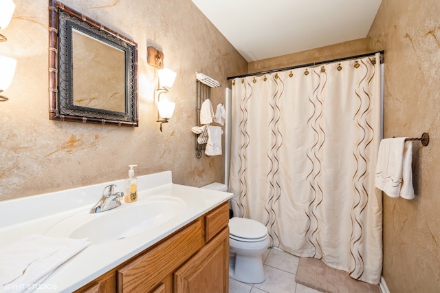 bathroom featuring vanity, tile patterned flooring, and toilet