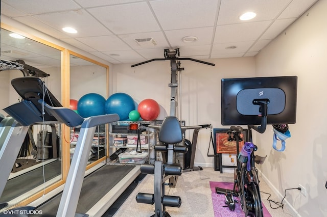 exercise area with a drop ceiling and carpet floors