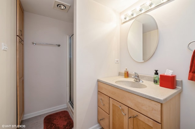 bathroom with vanity, an enclosed shower, and tile patterned floors