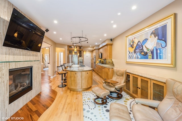 living room with light hardwood / wood-style floors and sink