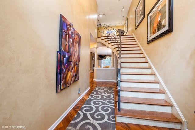 stairway with hardwood / wood-style floors