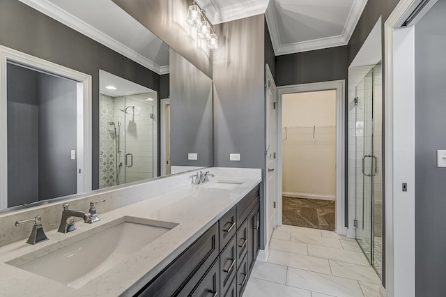 bathroom featuring a shower with shower door, crown molding, tile patterned flooring, and double sink vanity