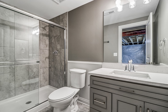 bathroom featuring vanity, a shower with shower door, toilet, and tile patterned floors