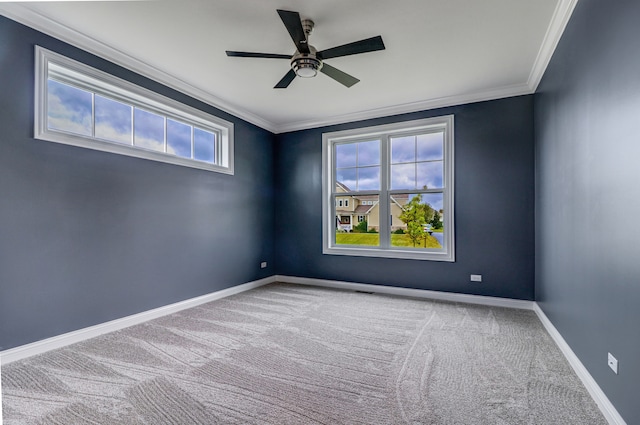 unfurnished room with ornamental molding, carpet flooring, and plenty of natural light