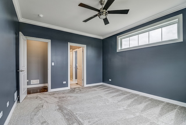 unfurnished bedroom with crown molding, ceiling fan, and light colored carpet