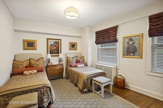 bedroom with radiator and light wood-type flooring