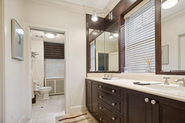 bathroom with toilet, vanity, ornamental molding, and tile patterned flooring