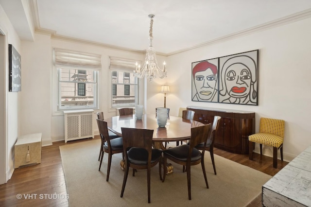 dining room with a notable chandelier, dark hardwood / wood-style flooring, crown molding, and radiator heating unit