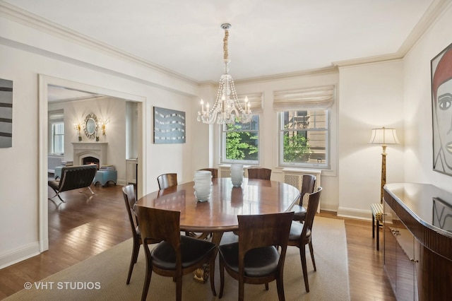 dining room featuring wood-type flooring, an inviting chandelier, and ornamental molding