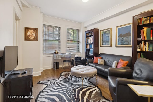 living room featuring dark hardwood / wood-style floors and ornamental molding