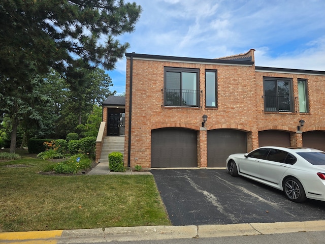 view of front of property featuring a garage and a front lawn