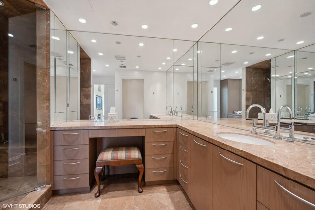 bathroom with vanity and a shower with shower door