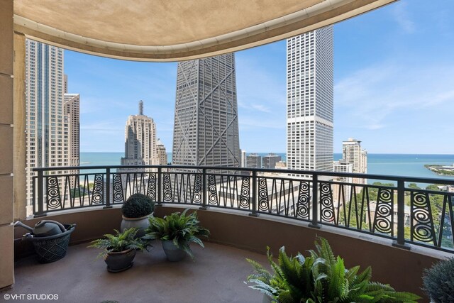 balcony featuring a water view