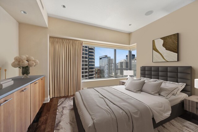 bedroom with dark wood-type flooring